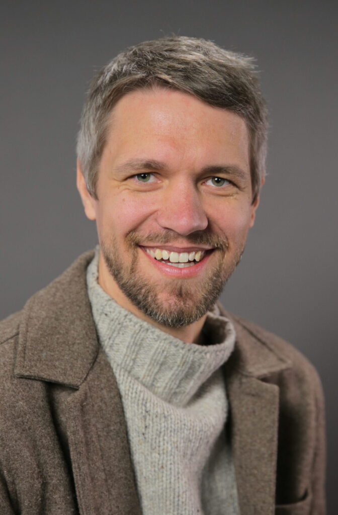 headshot of man smiling