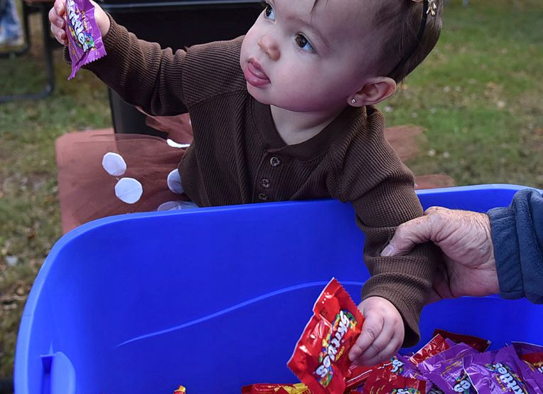 A toddler gets her hands on some candy at a Halloween event in Ashland, Ky. (Kevin Goldy/The Daily Independent via AP)