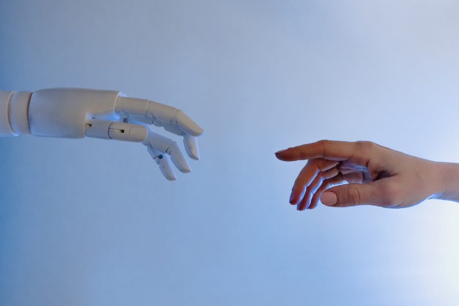 image of a robot hand meeting a human hand from opposite sides