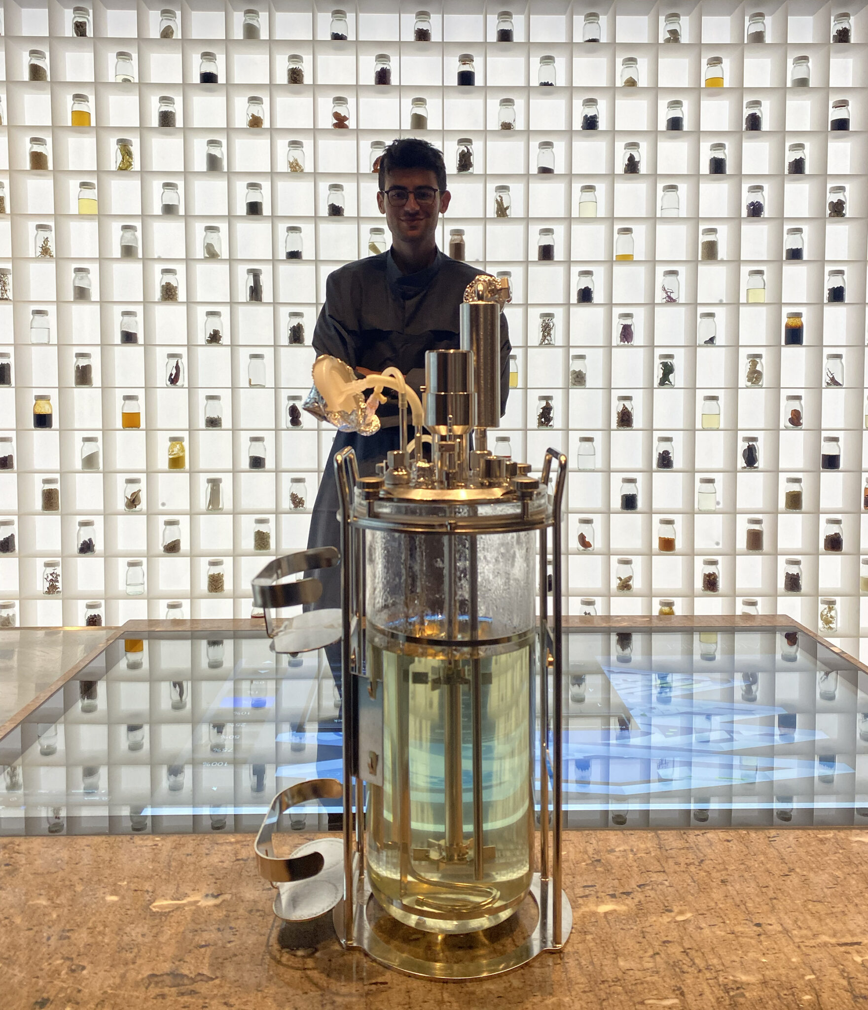 image of man standing in front of jars