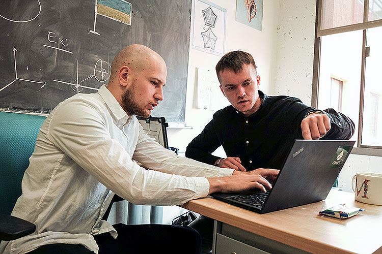 UC Berkeley Ph.D. students Igor Molybog (left) and Maksym Zubkov discussing strategy for using volunteer networks to provide food and medicine to people who can't flee Ukrainian hotspots
