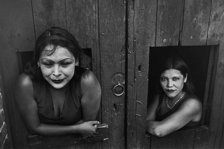 Sex workers posing in two windows.