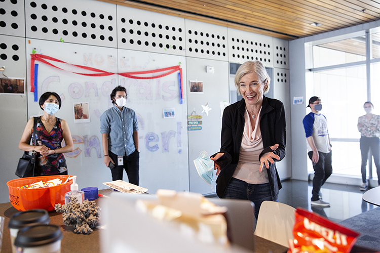 Jennifer Doudna smiles at people on her computer screen celebrating her Nobel Prize win