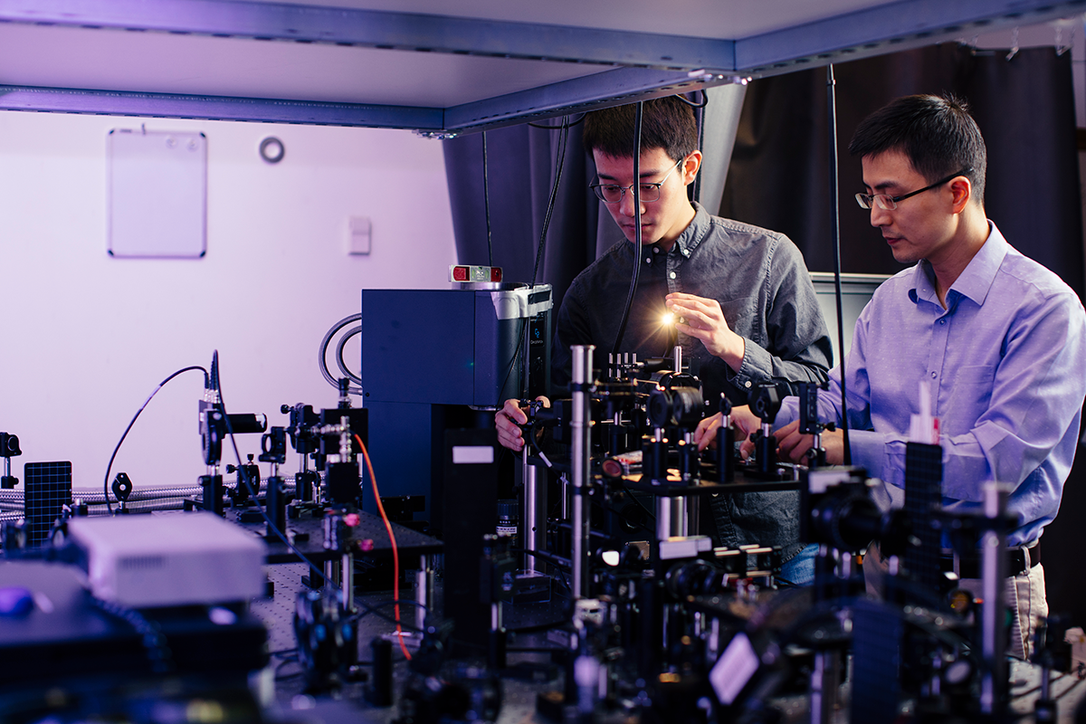 Jie Yao and Fanhao Meng in Yao Lab among equipment.