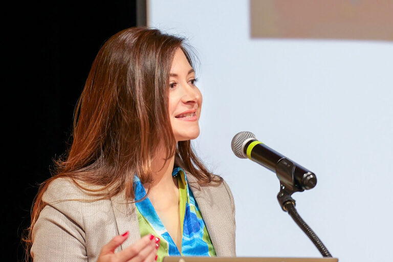 image of woman speaking into a microphone