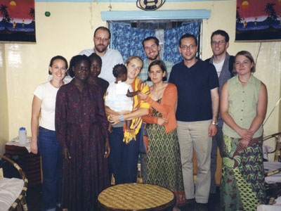 Miguel (third from right, in Kenya with Esther Duflo, fourth from right in orange sweater) and Michael Kremer (back left). Miguel's work with Kremer has been credited in the Nobel Memorial Prize in Economic Sciences.