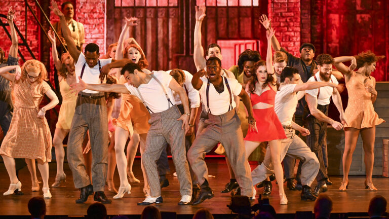 Performers on stage in the Broadway show, 