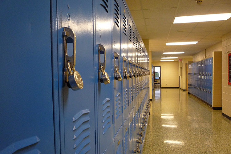 a row of blue lockers in a school hallway