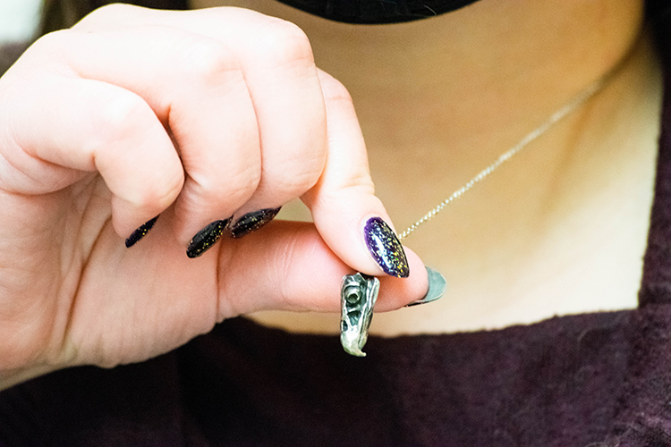 Mackenzie Kirchner-Smith fingers a vulture skull pendant her parents gave to her as a gift.