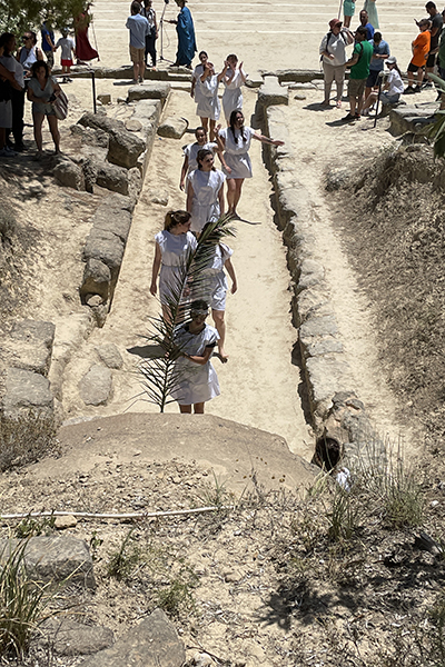 Barefoot runners, including UC Berkeley students, line up at the entrance tunnel to the stadium and track in Ancient Nemea, Greece