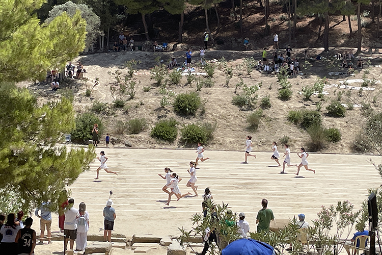 Spectators watch footraces at the 2024 Nemean Games on the slopes of the ancient stadium