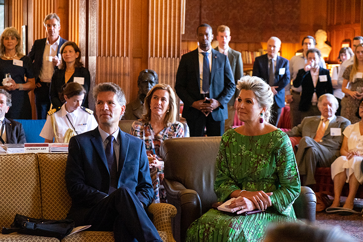 Queen Máxima, the queen of the Netherlands sits in the Morrison Library with Berkeley professor Jeroen Dewulf, listening to a presentation.