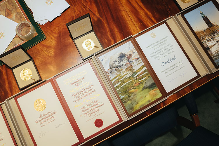 Nobel prize medals and diplomas on a table, getting ready for shipment to the US