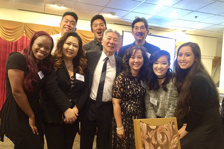 Michael Omi at a school fundraiser with students and faculty
