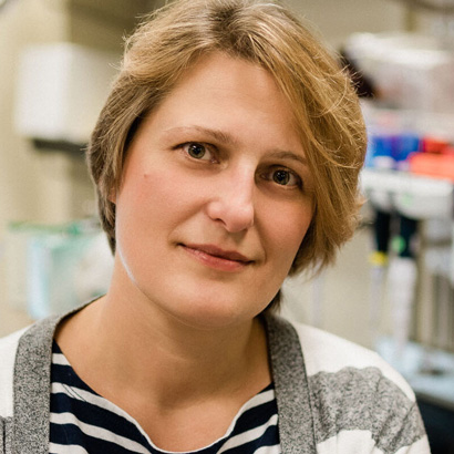 Polina Lishko in her lab in a black-and-white striped shirt