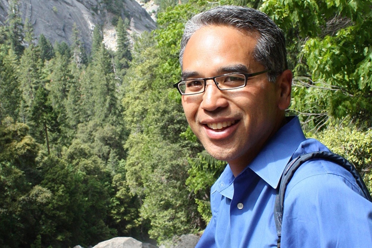 Patrick Gonzalez posing in front of trees