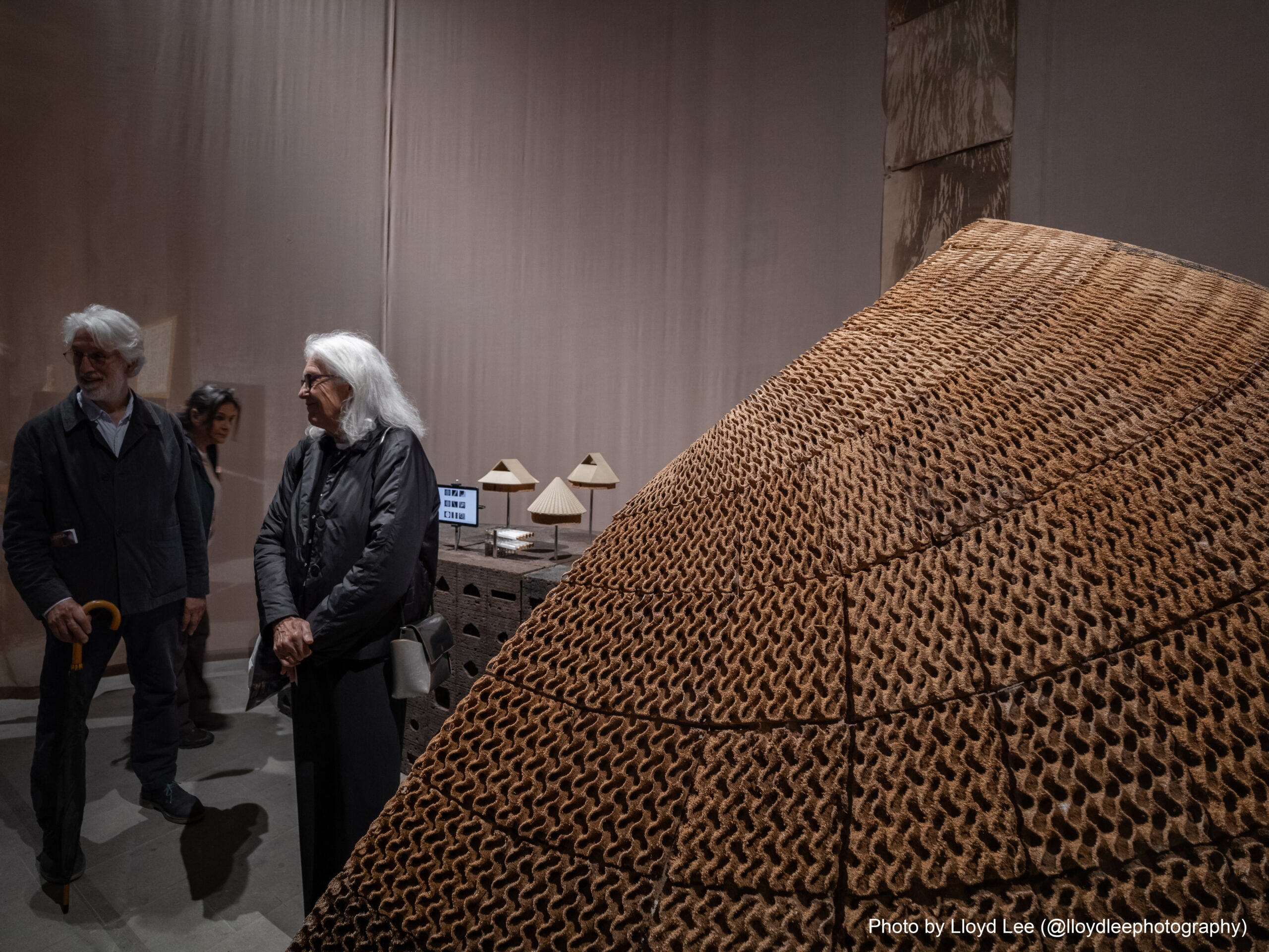 image of people standing admiring a piece of art