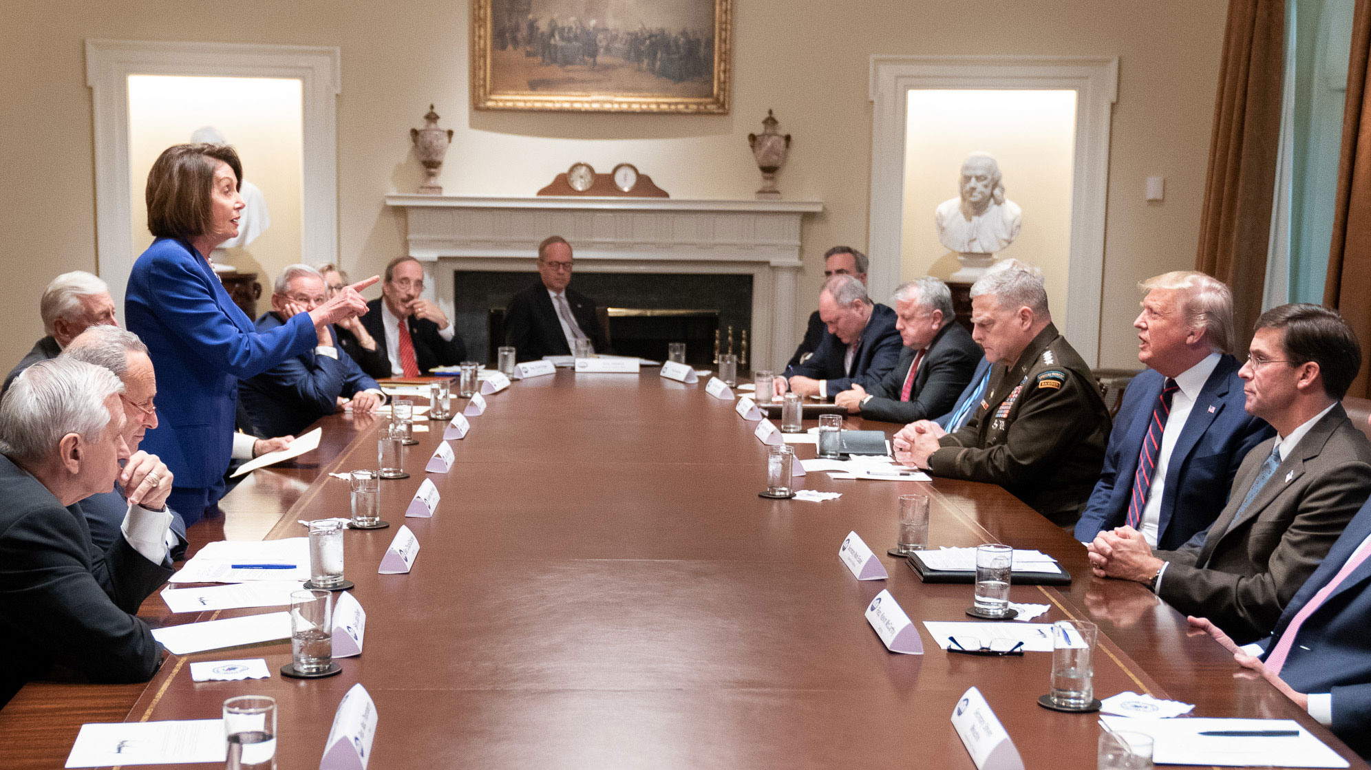 At a table in the White House dominated by men, House Speaker Nancy Pelosi lectures President Donald Trump