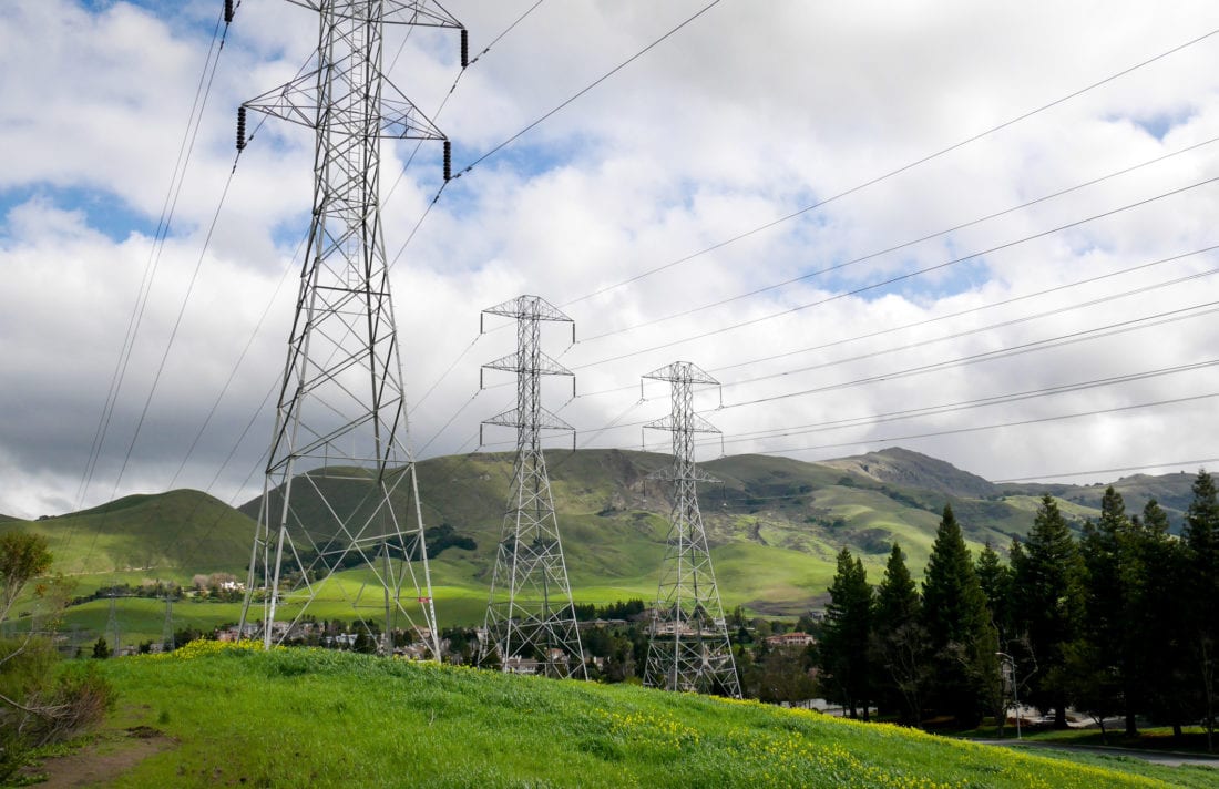 Power lines stretch across the landscape toward Mission Peak in Fremont, CA.