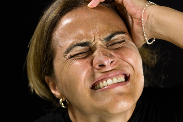 Woman holding her head in regret.