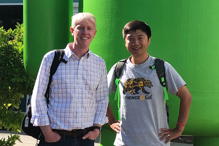 Richard Allen and Qingkai Kong in front of the green Android character at Google 