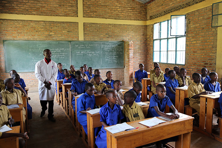 A teacher and his students in a classroom in Rwanda