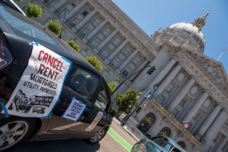 car plastered with "Cancel Rent" poster, part of a 2020 protest at San Francisco city hall