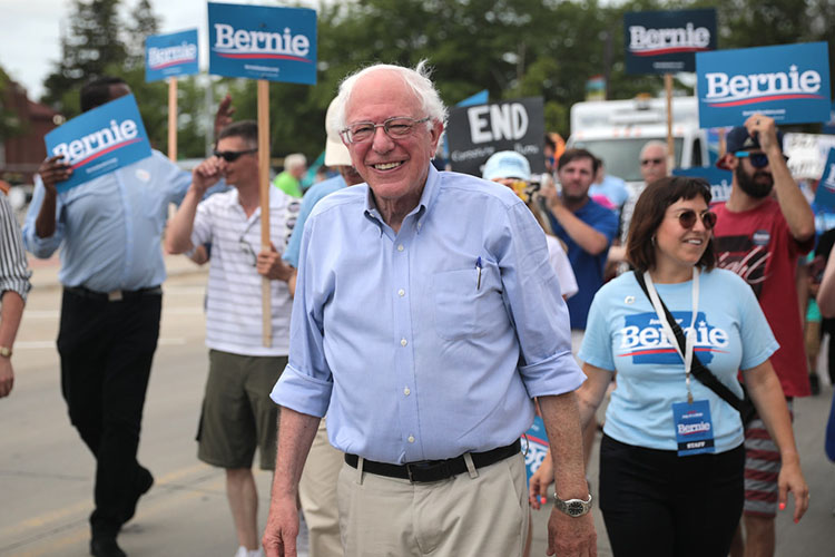 U.S. Sen. Bernie Sanders of Vermont at a Democratic presidential campaign event, surrounded by people carrying Bernie signs