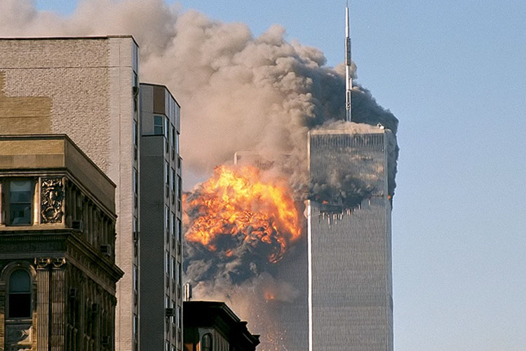 The twin towers of the World Trade Center engulfed in flames and smoke on the morning of Sept. 11, 2001