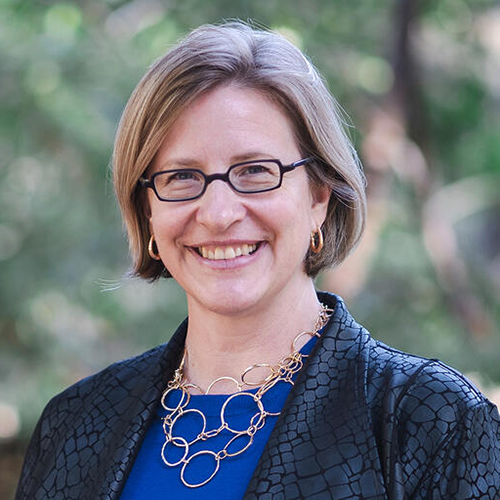 headshot of woman with glasses smiling