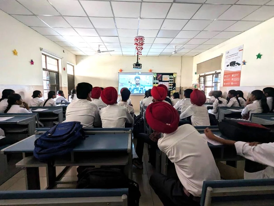 students in a classroom watching a film