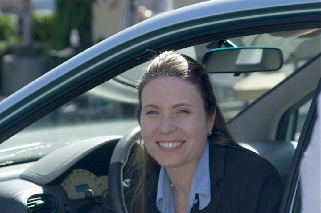 headshot of woman in car