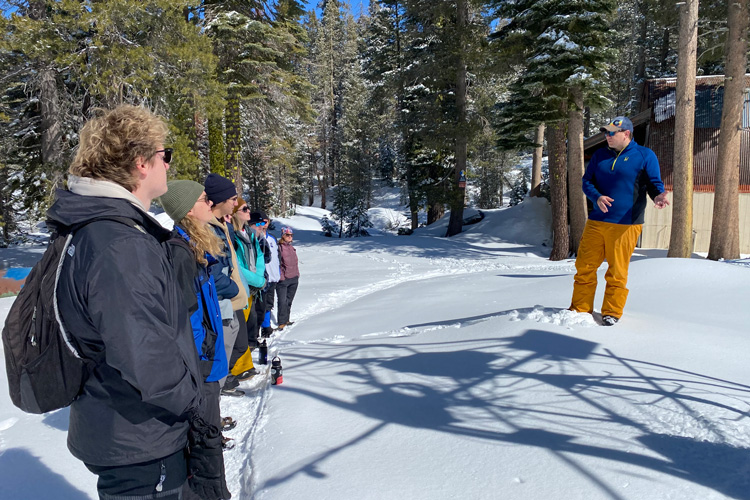 snow lab director tallks with students in the snow