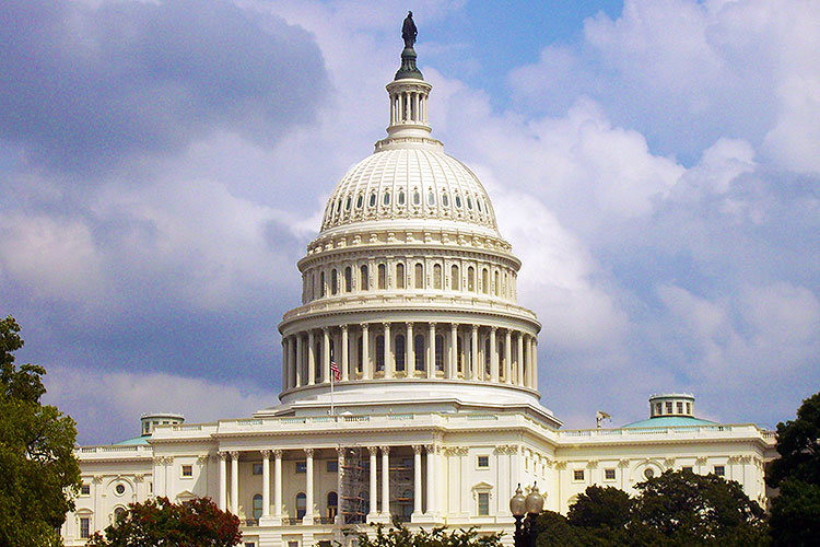 US Capitol building on a bright, partly cloudy day