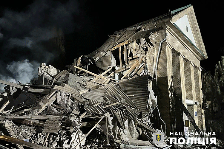 Against a nighttime sky, the rubble of a Ukrainian maternity hospital in the aftermath of a Russian missile strike