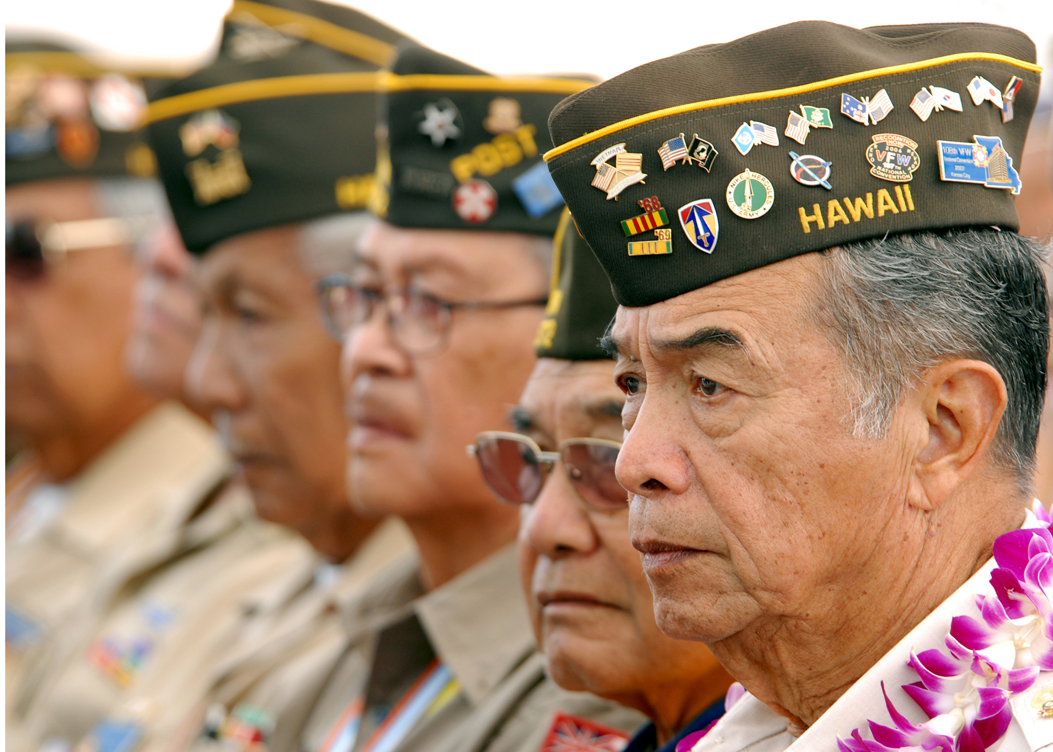 Filipinx Navy veterans wearing Hawaiian Navy hats.