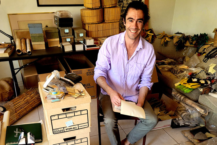 Zachary O'Hagan in the home of anthropologist Gerald Weiss packing up his Ashaninka collection.