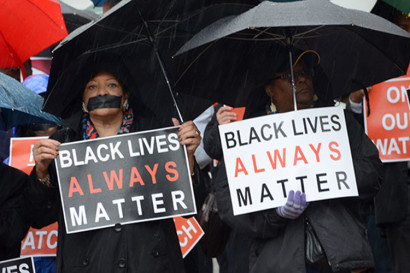 Protestors stand at a rally holding signs that say &quot;Black Lives Always Matter&quot;