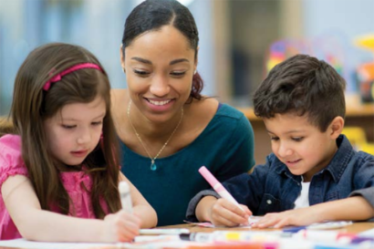 teacher working with 2 children