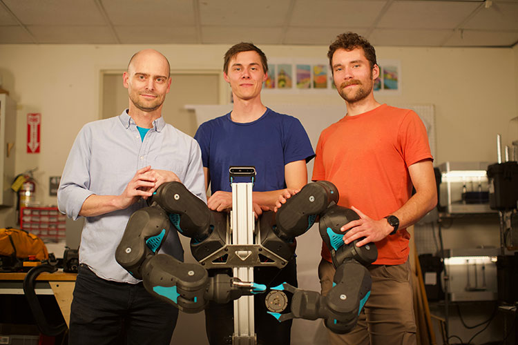 Pieter Abbeel, David Gealy and Stephen McKinley stand behind the Blue robot