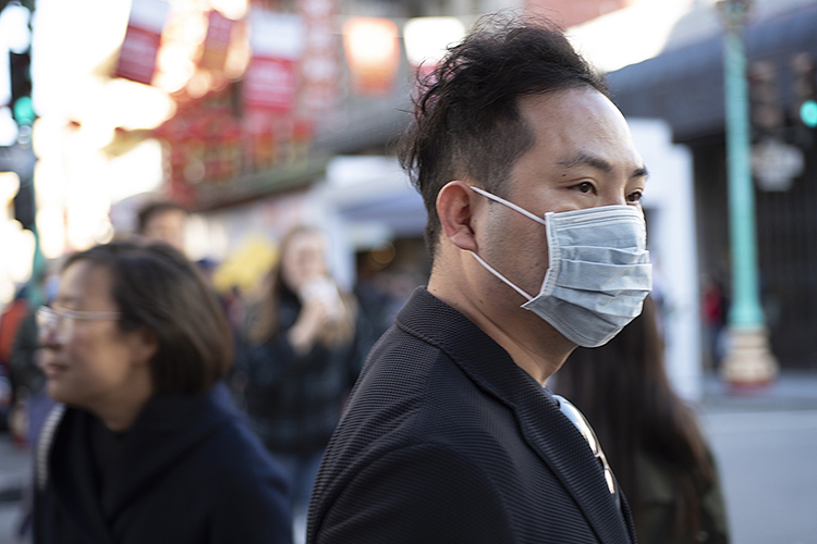 Man wearing medical mask in San Francisco's Chinatown.