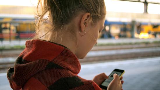 image of woman looking at her phone