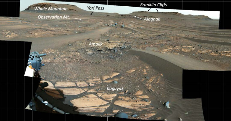 panorama of gray and red surface of Mars, with parts of rover in foreground