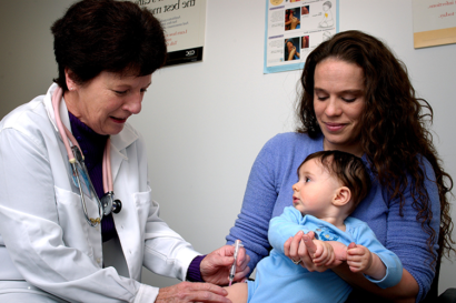 Health worker with mother and child.