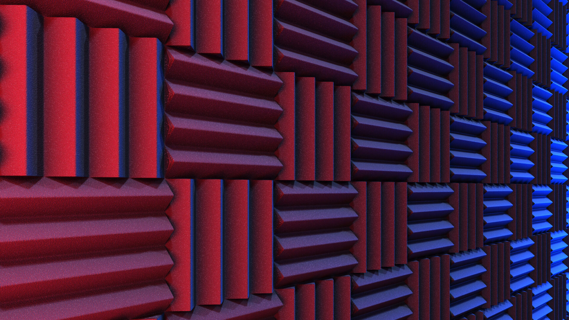 Wall of acoustic foam panels in criss-cross pattern cast in red and blue light.