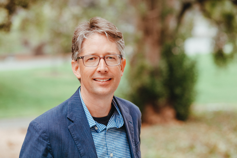 image of man in glasses smiling 