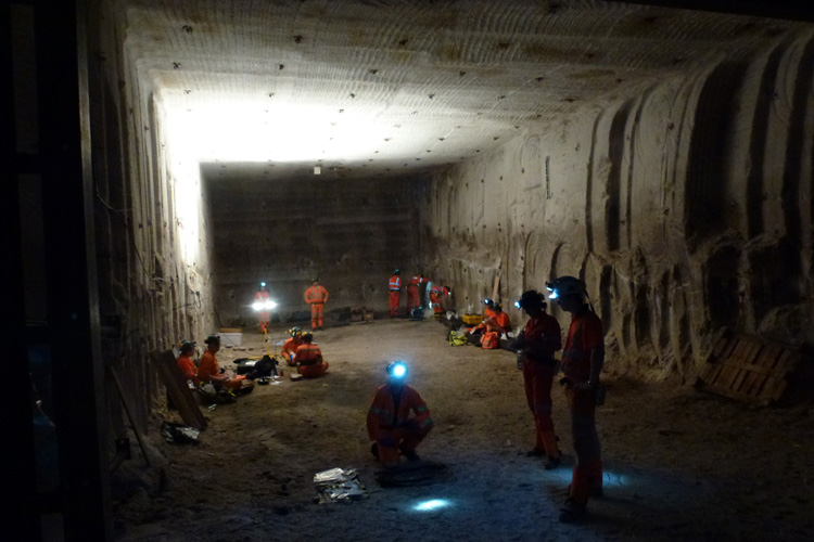 Many people standing in excavated cavern in Boulby mine