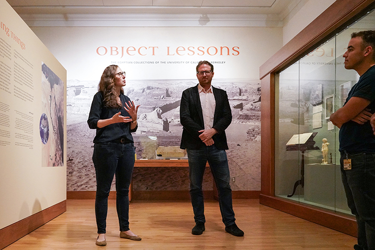 two people standing in front of an exhibit