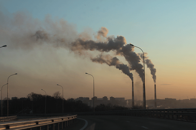 A photo shows smoke coming from smokestacks