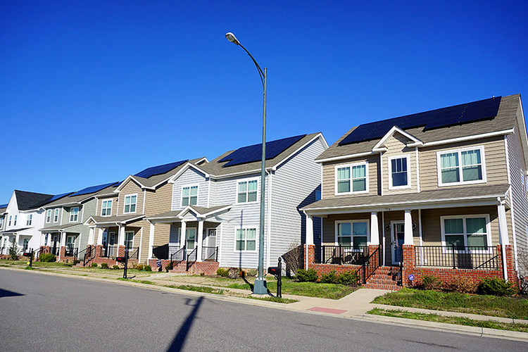 row of houses with solar panels on the roofs